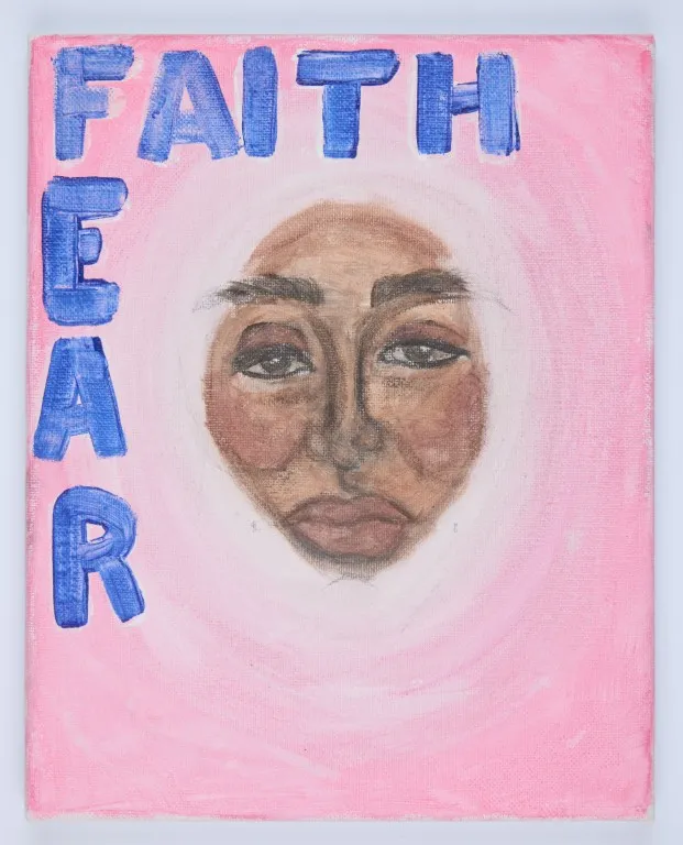 A portrait painting on a pink canvas. At the top, the word "FAITH" is painted in blue block letters. The letters for "FEAR" are stacked vertically on the left side, also in blue. In the center is a portrait of a person's face with a brown complexion, a soft gaze, and a slight frown. The face is surrounded by a white halo, with a light pink ring around it, all set against a solid pink background.