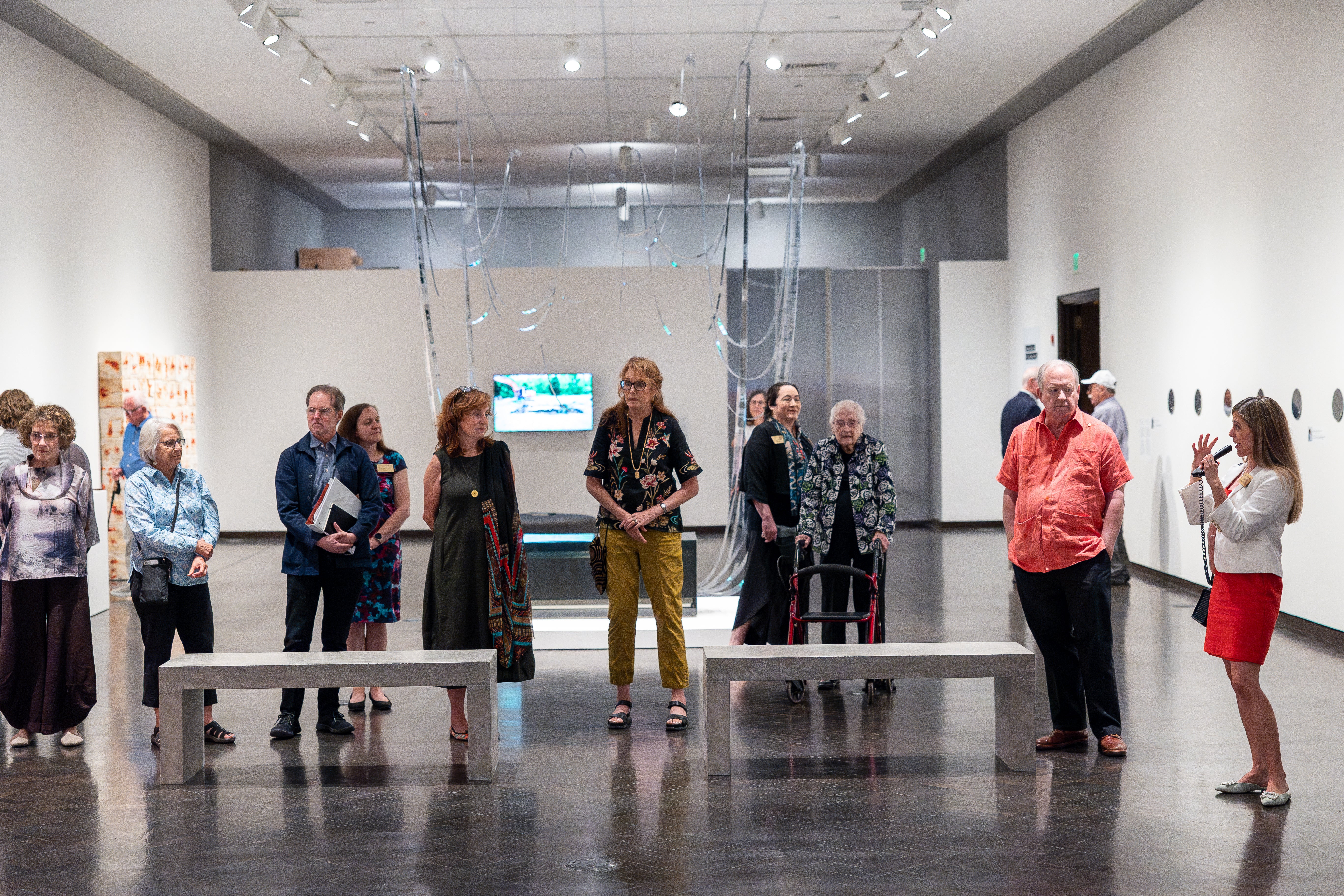A group of people look at art in the exhibition Necroarchivos: The Unrelenting Search for Justice