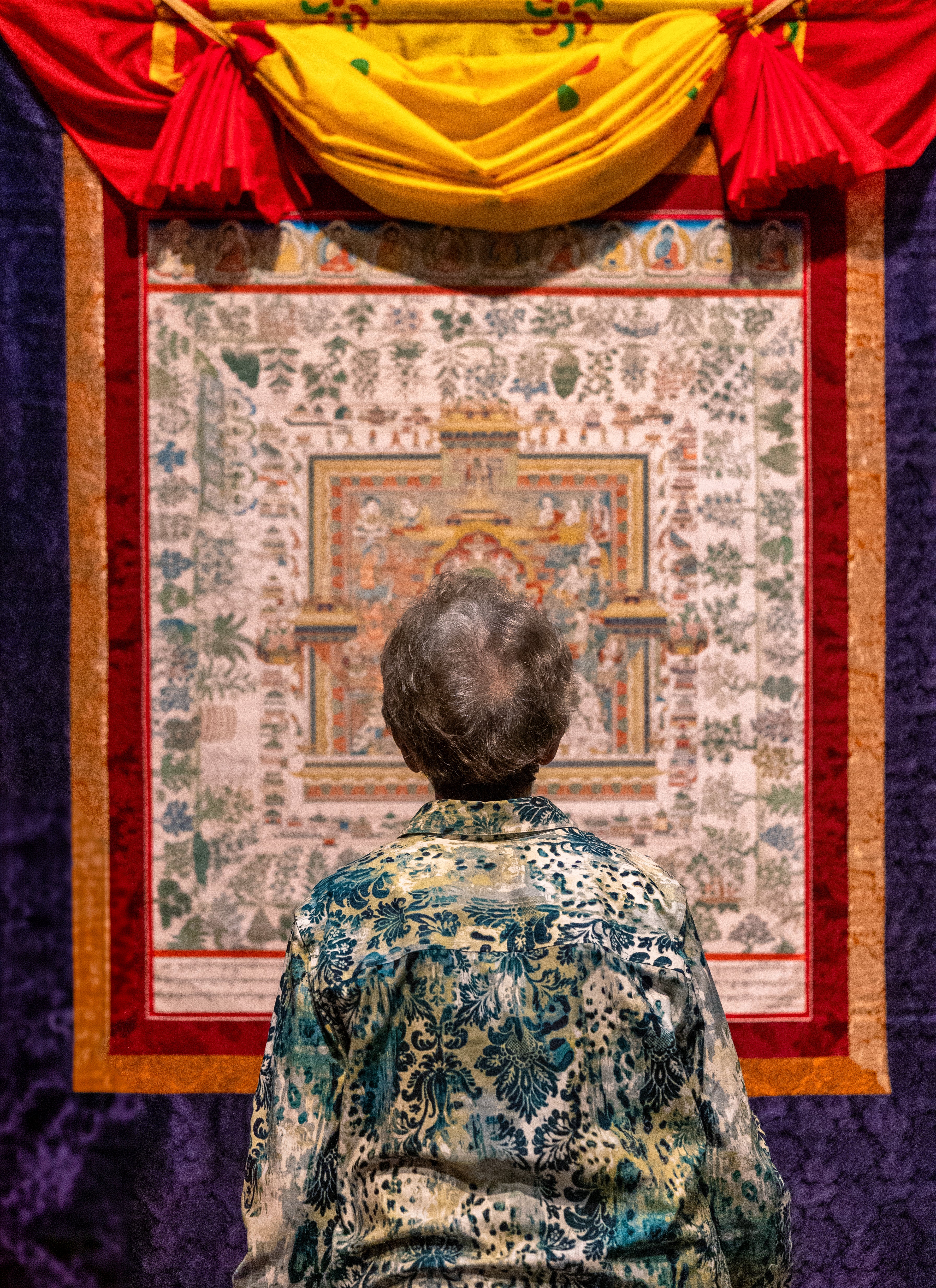 Back of woman looking at work of art