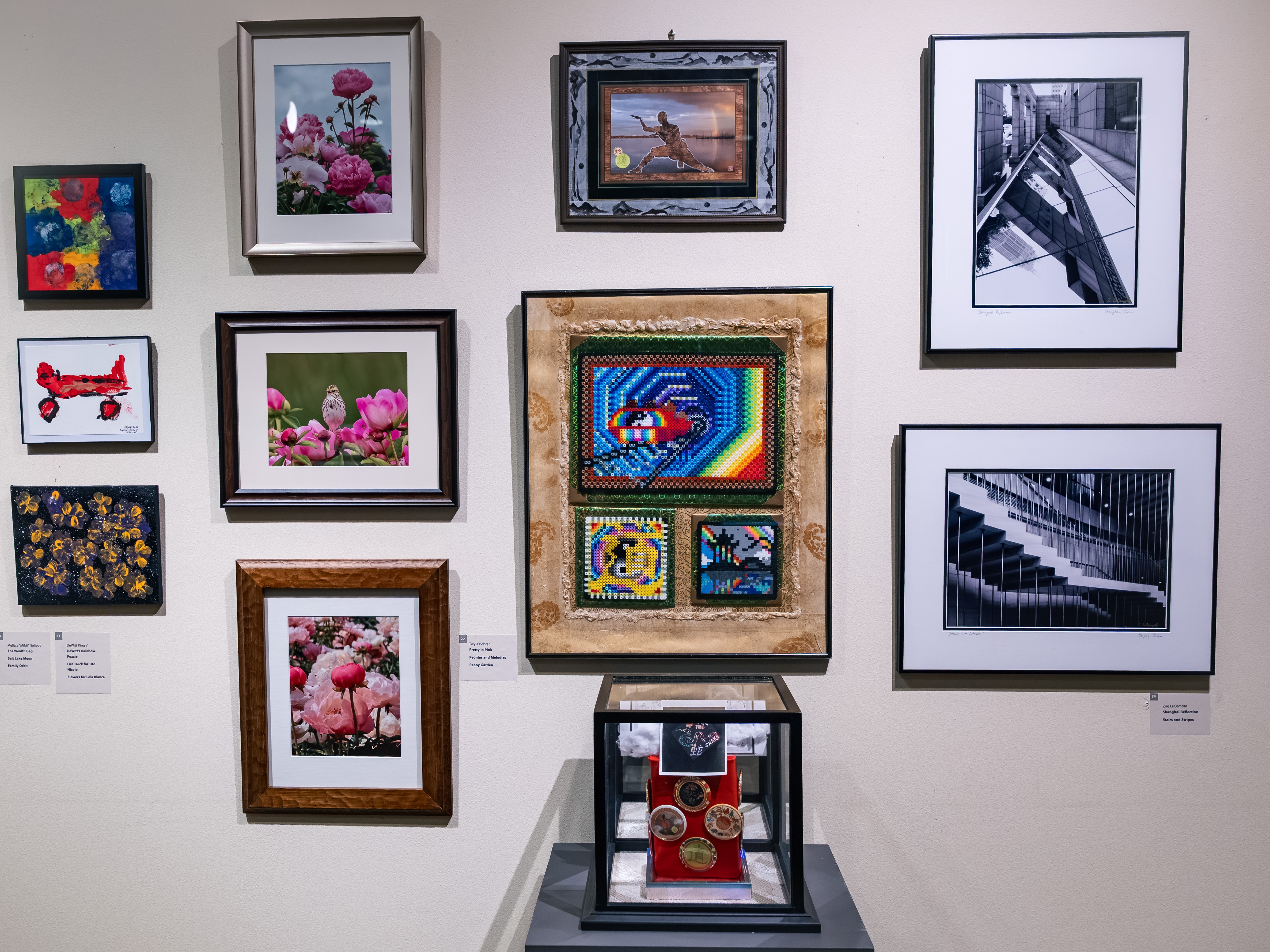 Gallery wall with multiple artworks installed. 